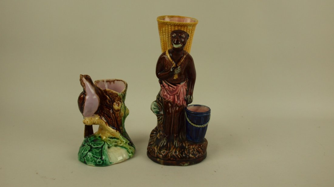 Majolica pair of figural vases: bird and monkey with: Majolica pair of figural vases: bird and monkey with basket (rim repair to basket)