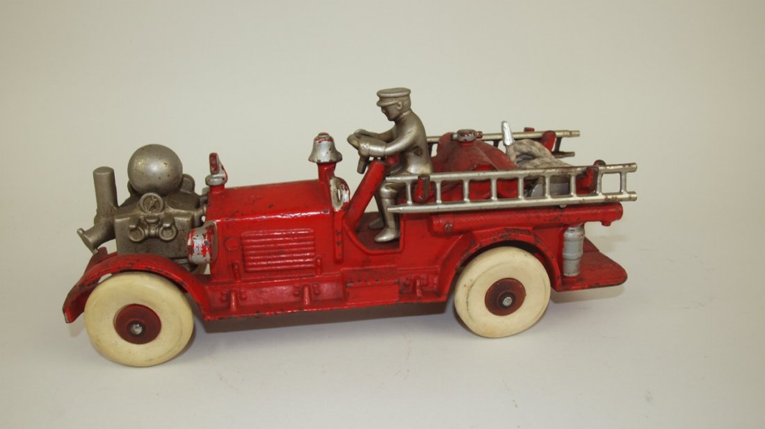 Cast iron fire truck with driver, complete with 2: Cast iron fire truck with driver, complete with 2 ladders and hose reel