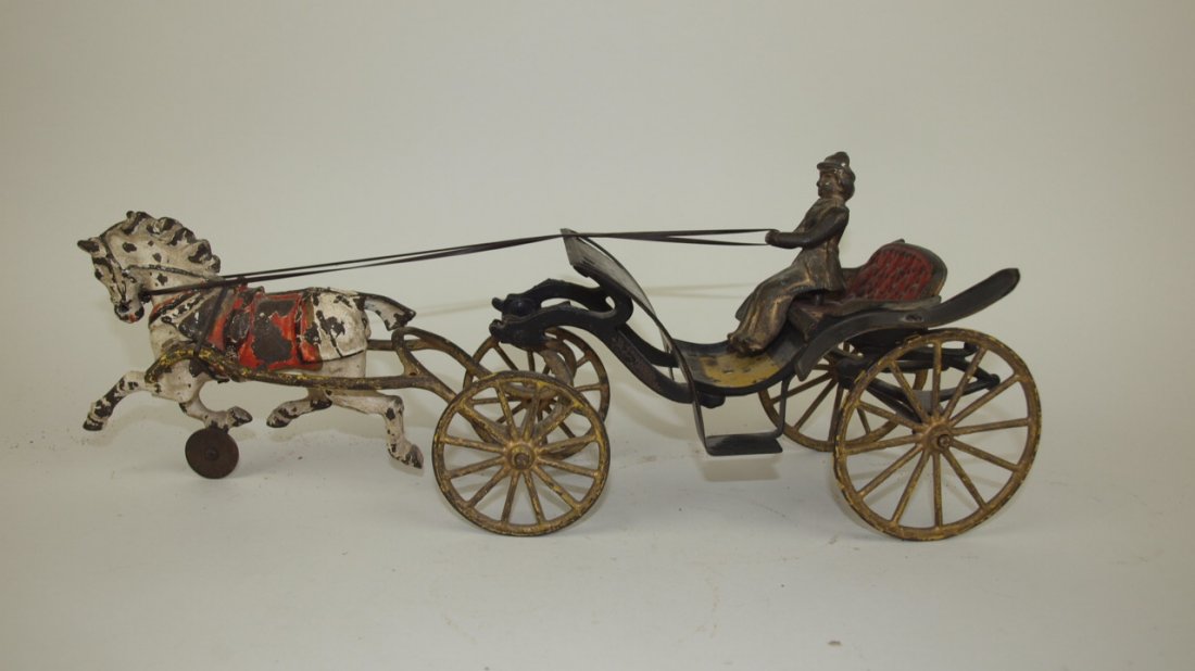 Cast iron and metal surrey with lady driver, loss to: Cast iron and metal surrey with lady driver, loss to half the horses tail, 15 1/2"
