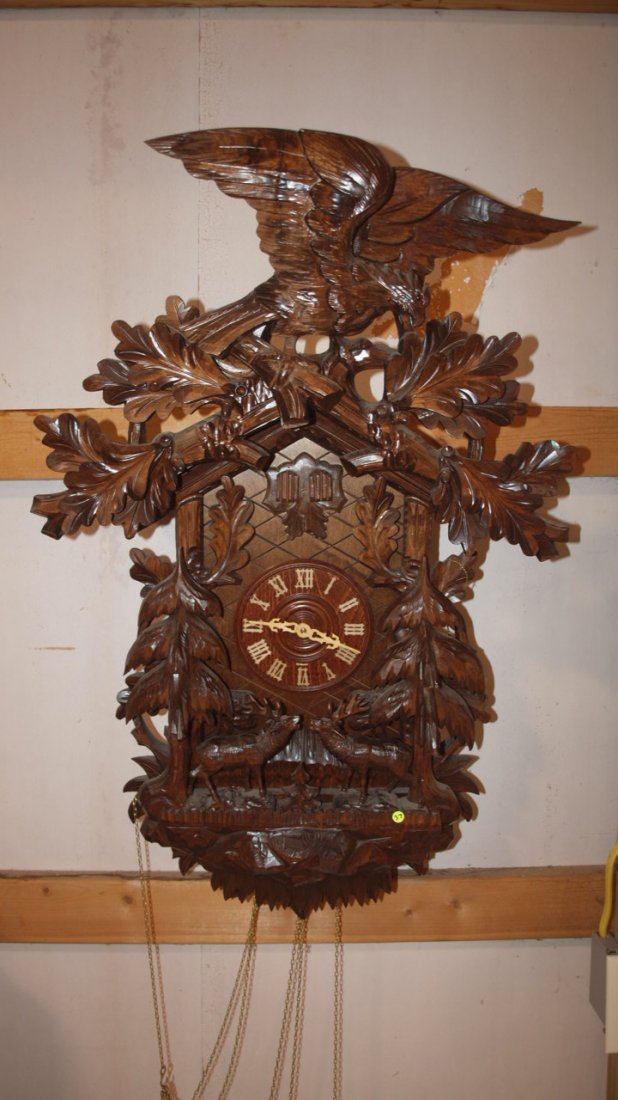 German black forest contemporary cuckoo clock, plays 3: German black forest contemporary cuckoo clock, plays 3 songs, carved eagle tip with stag deer & pine trees, 3 weights, 36"h. 22" w, made by Rombach & Haas