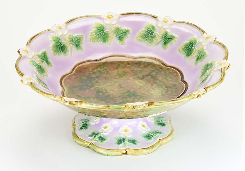 A George Jones Majolica 'Strawberry Blossom' Fruit: A George Jones Majolica 'Strawberry Blossom' Fruit Stand c.1875. The pink ground bowl and pedestal base with a shaped edge and decorated with a continuing band of apple blossoms and leaves, the bowl w