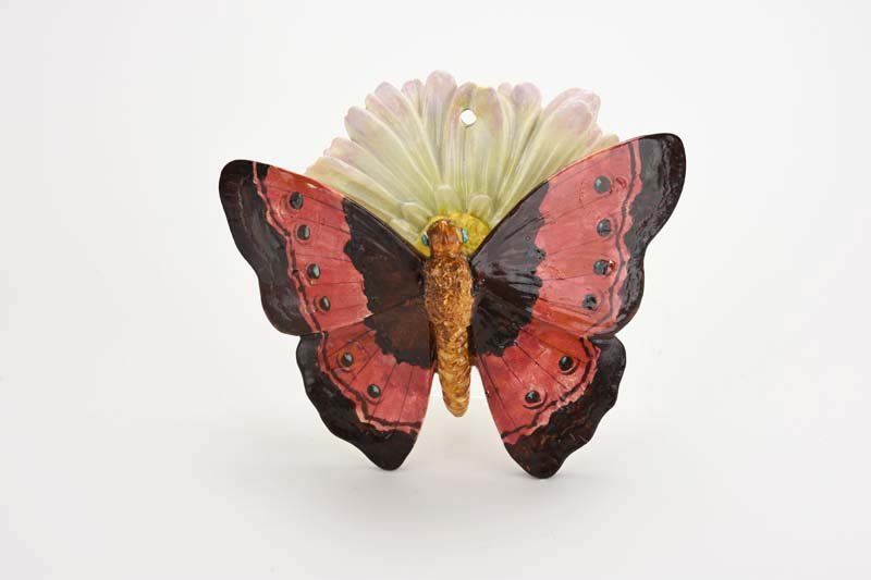A Large Jerome Massier Majolica Butterfly Wall pocket: A Large Jerome Massier Majolica Butterfly Wall pocket c.1880. Modelled as a butterfly with outstretched red and purple wings and a flower back plate with white and pink petals. Catalogued and curated