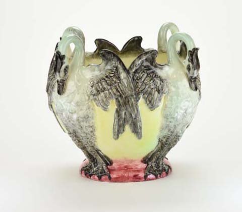 A Very Rare Delphin Massier Majolica ‘Swans’ Jardiniere: A Very Rare Delphin Massier Majolica ‘Swans’ Jardiniere c.1880. The rounded body molded with four back to back swans with grey wings, their arched necks forming four handles and all stood on a red
