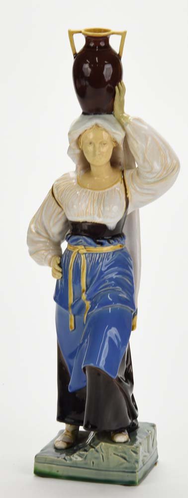 A Very Rare Minton Majolica Figure ‘Neapolitan Water: A Very Rare Minton Majolica Figure ‘Neapolitan Water Carrier’ c.1860. Shape no.180. Modelled as a woman in 18th Century Italian costume and supporting a vase on her head. This design was to be mad
