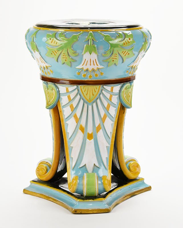 A very rare and important George Jones Majolica: A very rare and important George Jones Majolica Neo-Classical garden seat c.1870, designed with three scroll legs with stylised white palm leaves with yellow highlights, the apron with stylised lotus 