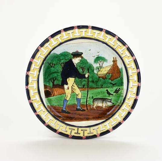 A Very Rare Wedgwood Majolica Plate Depicting October: A Very Rare Wedgwood Majolica Plate Depicting October from the Months of the Year Series c. 1875, never seen before. The design originally for a tile depicting a young man in 18th century dress holdin