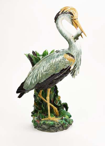 A Magnificent Rare Hugo Lonitz Majolica Heron: A Very Rare Hugo Lonitz Monumental Majolica Heron Pedestal, c. 1880, modeled as a grey heron with a fish clenched in his beak stood next to a clump of reed, leaves and bulrushes forming the pedestal,