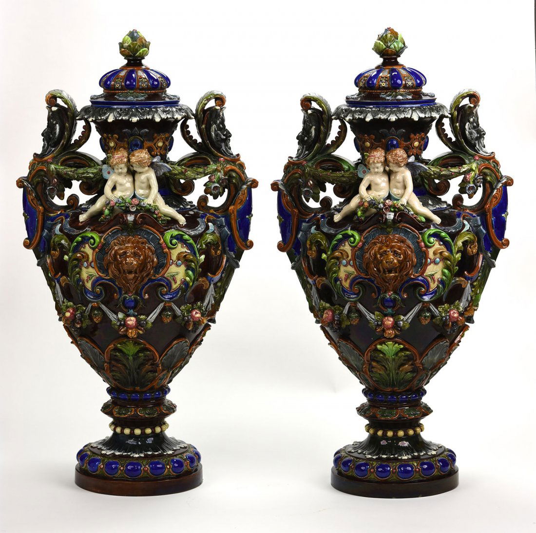A Magnificent Rare Pair of Hugo Lonitz Urns and Covers: Magnificent, Rare Pair of Monumental Hugo Lonitz Majolica Renaissance Revival Urns and Covers, c. 1880, each modeled as a cobalt blue urn with circular pedestal base decorated with cabachon, the bodie