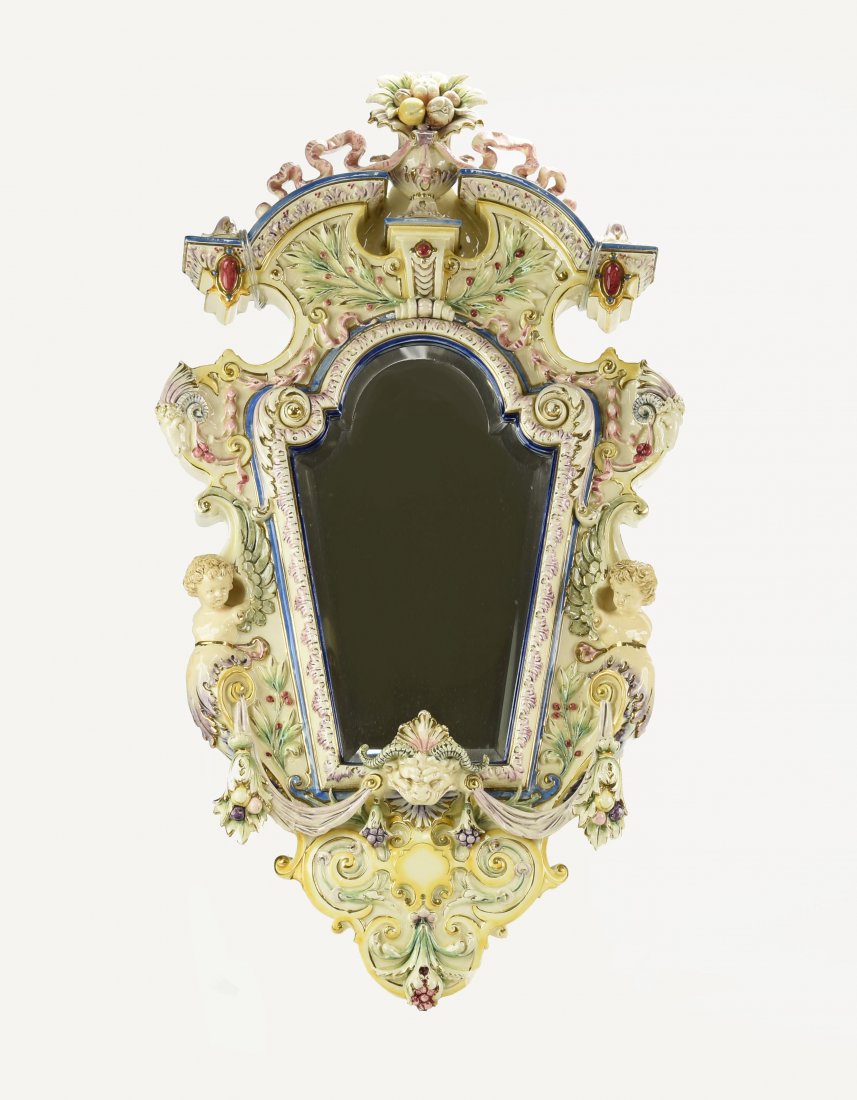 Hugo Lonitz pastel majolica beveled wall mirror with: Hugo Lonitz pastel majolica beveled wall mirror with cherubs and goats heads, 32 1/2"h, 17"w, various losss and repairs