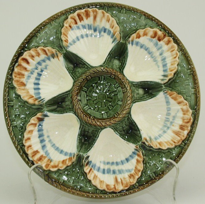 Longchamp Majolica 6 well oyster plate with cream,: Longchamp Majolica 6 well oyster plate with cream, blue, & brown shell wells on green basket weave ground, ref: Karsnitz pg. 20, 9 1/2"