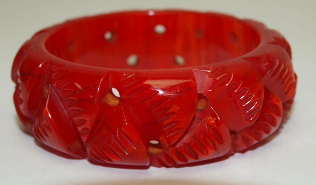 Red bakelite bangle bracelet with deeply carved leaves (1 of 1)
