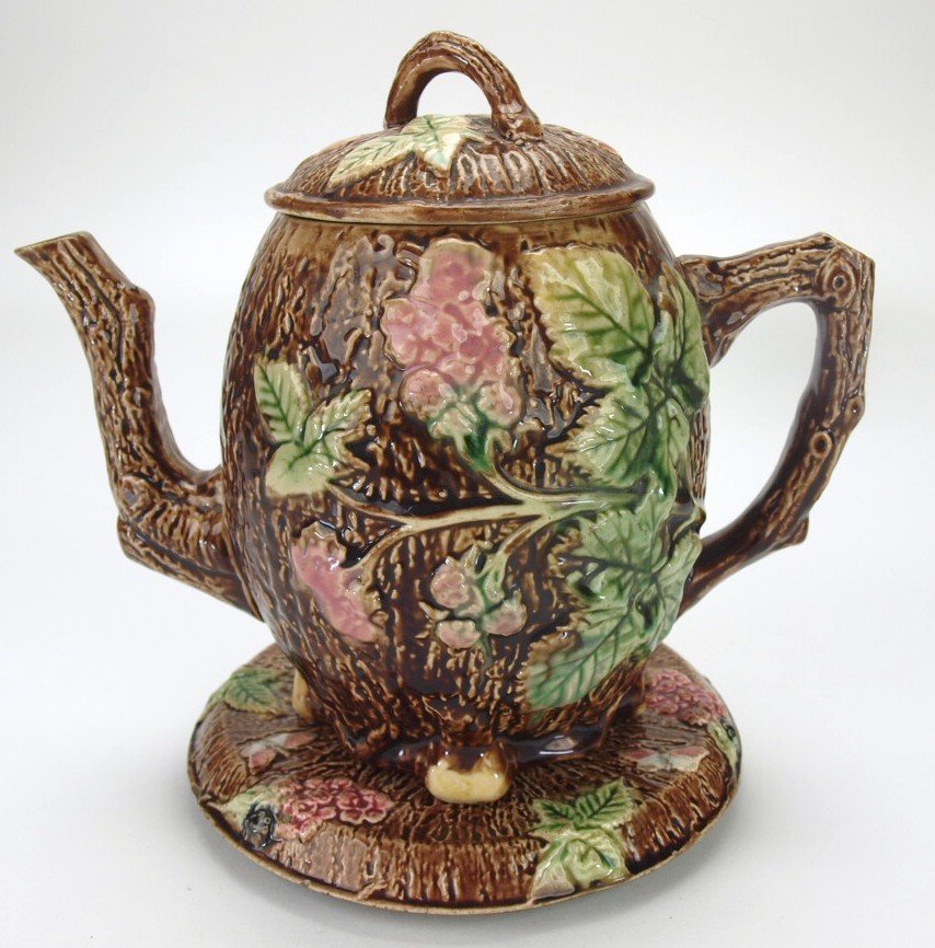 Majolica rustic teapot with matching trivet, 8", rim: Majolica rustic teapot with matching trivet, 8", rim repair to trivet