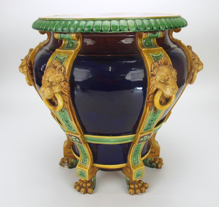 Minton majolica cobalt lion strap jardiniere with paw: Minton majolica cobalt lion strap jardiniere with paw feet, chips to feet and rim, 17 1/2"