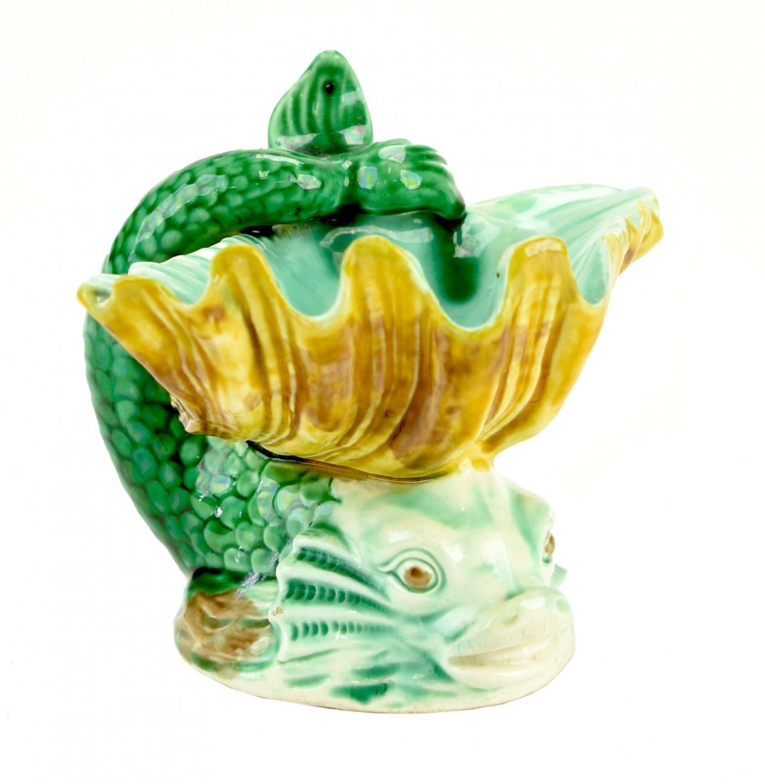 A Wedgwood Majolica Dolphin Salt c.1860 Designed by: A Wedgwood Majolica Dolphin Salt c.1860 Designed by John Bell for The Art Union. Modeled as green dolphin with tail in the air supporting a clam shell on its head. by John Bell for The Art Union. Mode