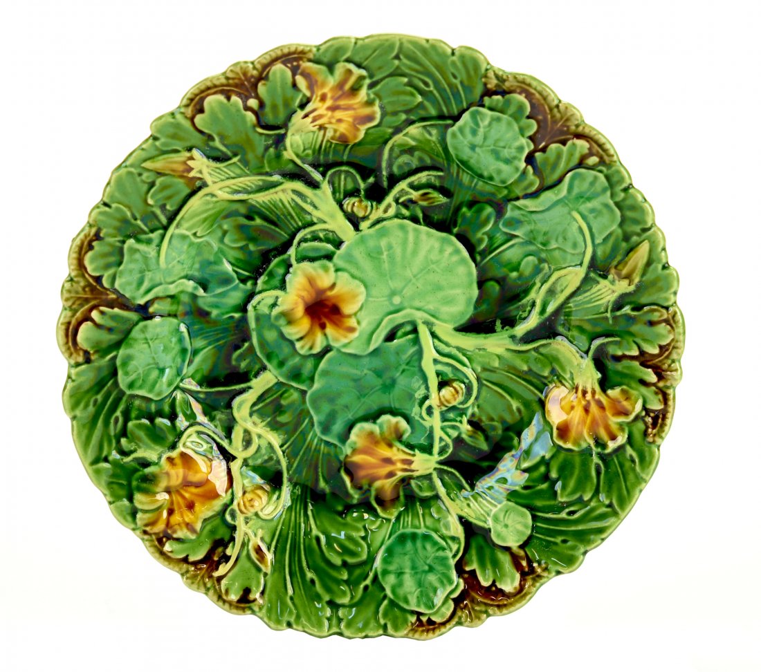 A Very Desirable Minton Majolica Geranium Dessert Plate: A Very Desirable Minton Majolica Geranium Dessert Plate c.1860. The shaped edge plate decorated with group of overlapping green leaves and geraniums against a dark ochre ground, 9” Plate c.1860. The