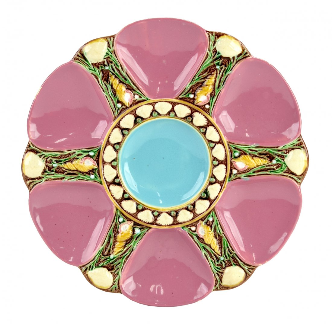 A Fine Quality Minton Majolica 6 well Pink oyster plate: A Fine Quality Minton Majolica 6 well Pink oyster plate c.1875 Modeled as a circular plate with pink wells separated by shells and seaweed, the turquoise circular central well surrounded by conch shel