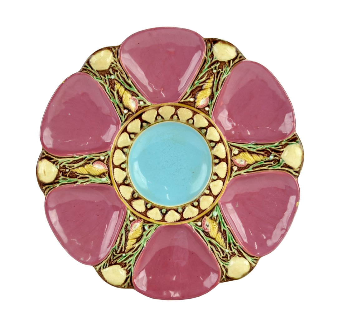A Fine Quality Minton Majolica 6 well Deep Pink oyster: A Fine Quality Minton Majolica 6 well Deep Pink oyster plate c.1875 Modeled as a circular plate with deep pink wells separated by shells and seaweed, the turquoise circular central well surrounded b