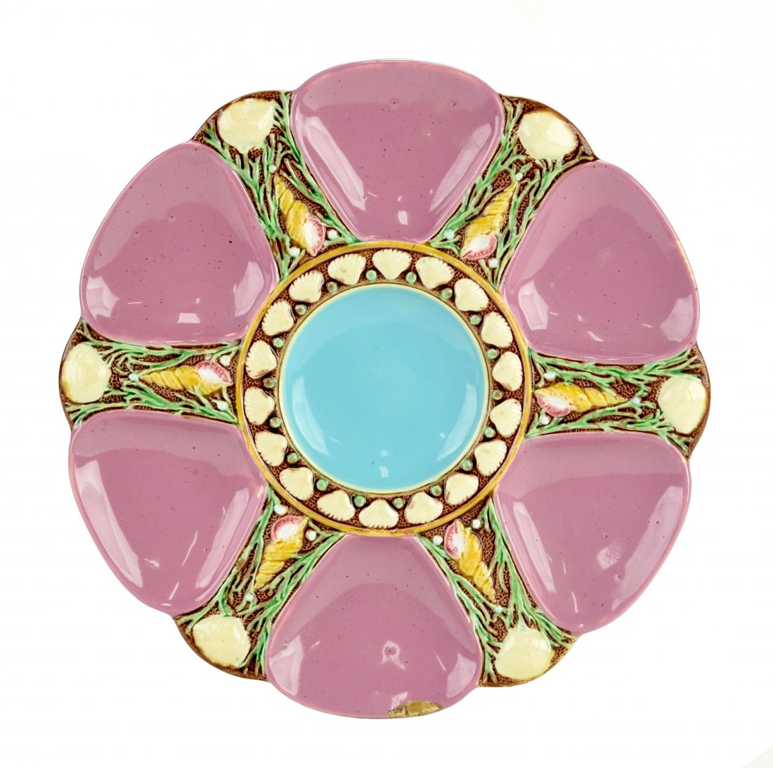 A Fine Quality Minton Majolica 6 well Pink oyster plate: A Fine Quality Minton Majolica 6 well Pink oyster plate c.1875 Modeled as a circular plate with pink wells separated by shells and seaweed, the turquoise circular central well surrounded by conch shel