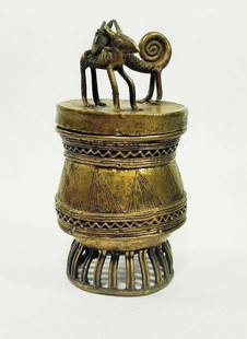 Ashanti Gold Dust Box | Ghana | Brass: Ghana, Ashanti. Gold dust box made of brass. Very heavy, Ashanti box. Round lid has a dog like creature on the back of a goat or sheep. The body has a decorative pattern that repeats at the bottom.