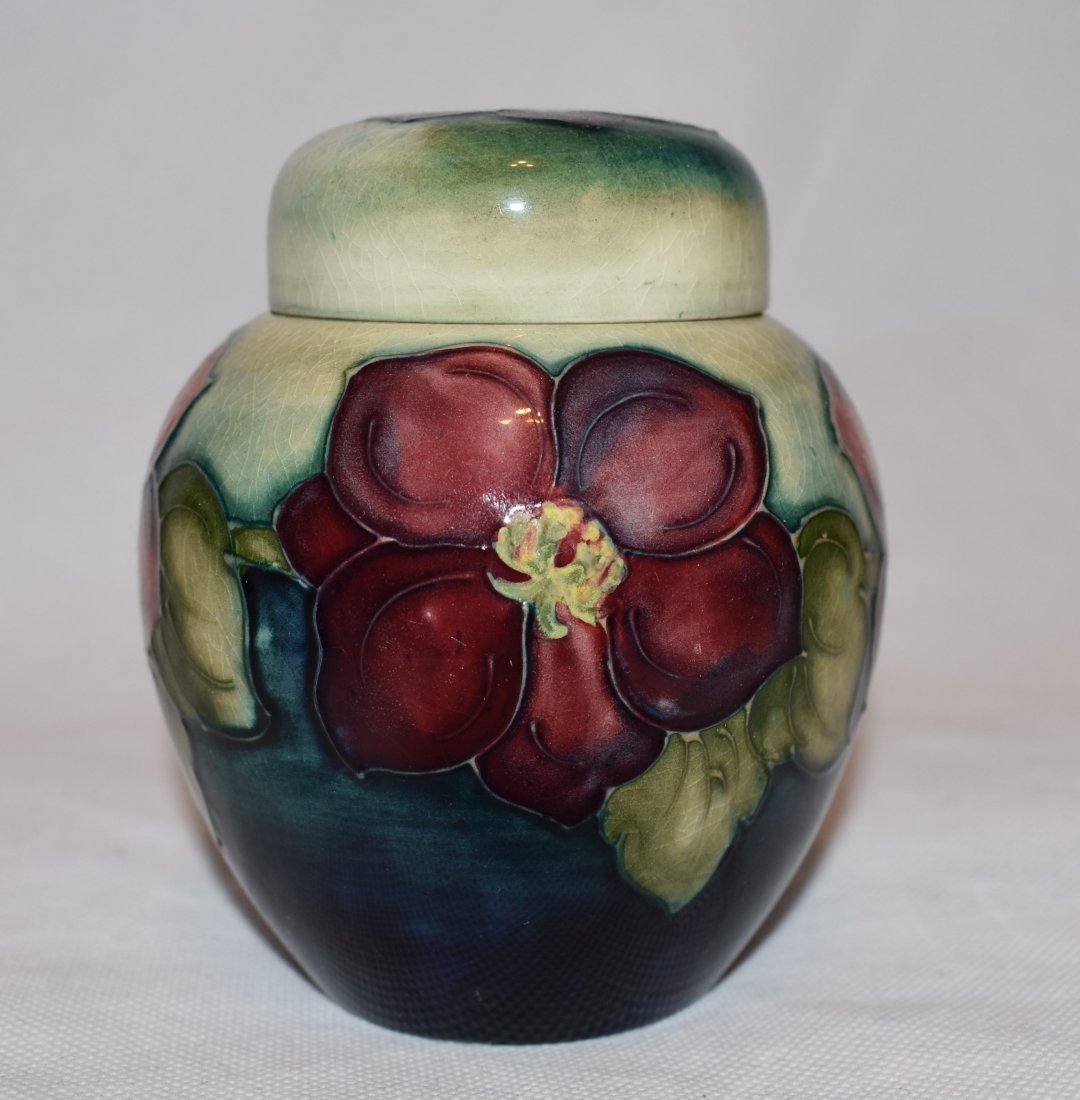 Moorcroft | Lidded Ginger Jar: Moorcroft Moorcroft lidded ginger jar decorated with clematis on a green coloured ground, Moorcroft marks to base and lid and small M visable on base. Dimensions H:11cm or 4,33 Inches Shipping Austria