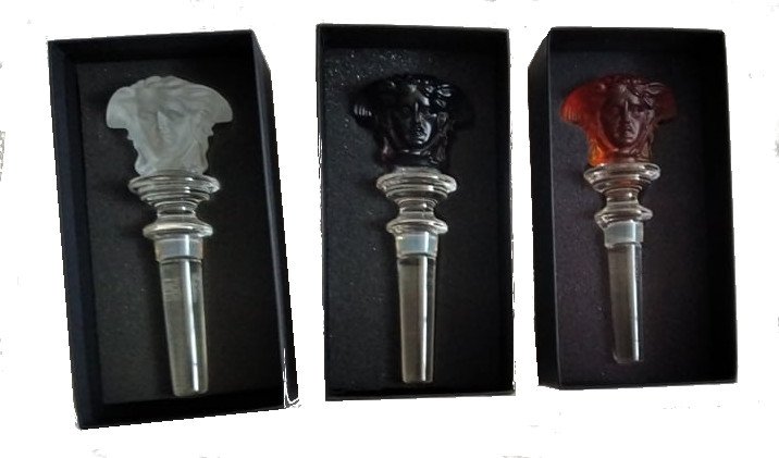 Versace Rosenthal | Glass Bottle Stoppers | Lot of 3: Lot of 3 Versace Rosenthal glass bottle stoppers in original packaging. Design: Versace Execution: Rosenthal Date: Contemporary Description: Set of 3 stoppers, molded glass/ crystal. In three colors;