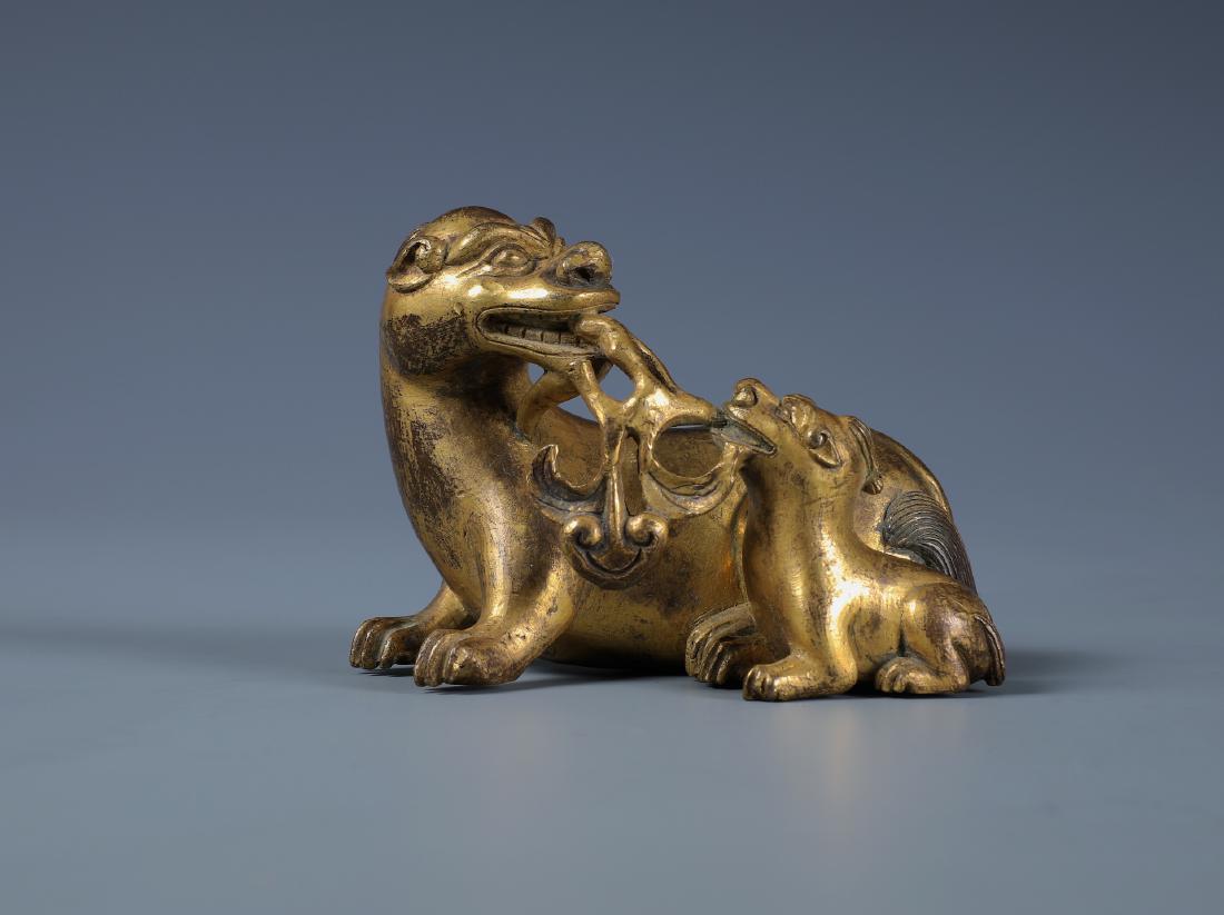 A SMALL FINELY CAST GILT-BRONZE MYTHICAL TWIN (1 of 7)