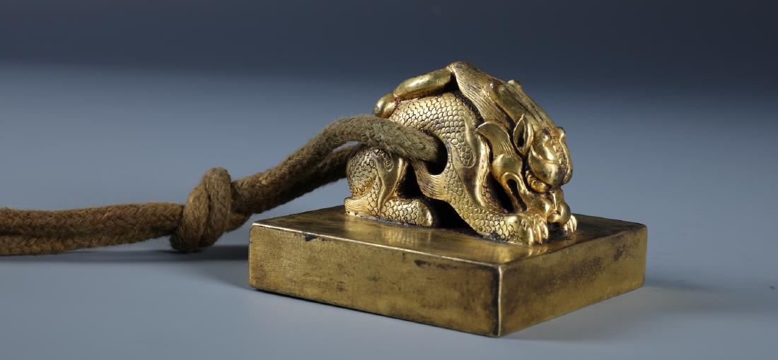 A CHINESE GILT BRONZE SEAL WITH CHILONG HANDLE (1 of 5)