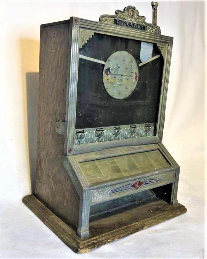 Jennings Rockaway 5 Cent Coin Operated Game Stimulator: Jennings Rockaway 5 Cent Coin Operated Game Stimulator. All original as found, no key, glass slant panel has a crack, metal frame all in good shape, oak case and back also all in good shape. Size: 21