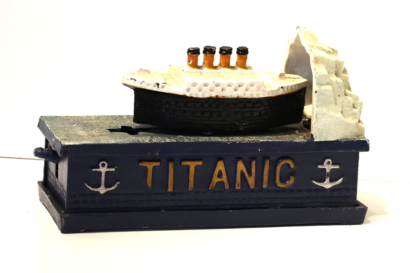 Novelty Cast Iron TITANIC Mechanical Coin Bank in Original Paint Finish: Novelty Cast Iron TITANIC Mechanical Coin Bank in Original Paint Finish. size 5 in. height x 7 in. length x 3 in. wide