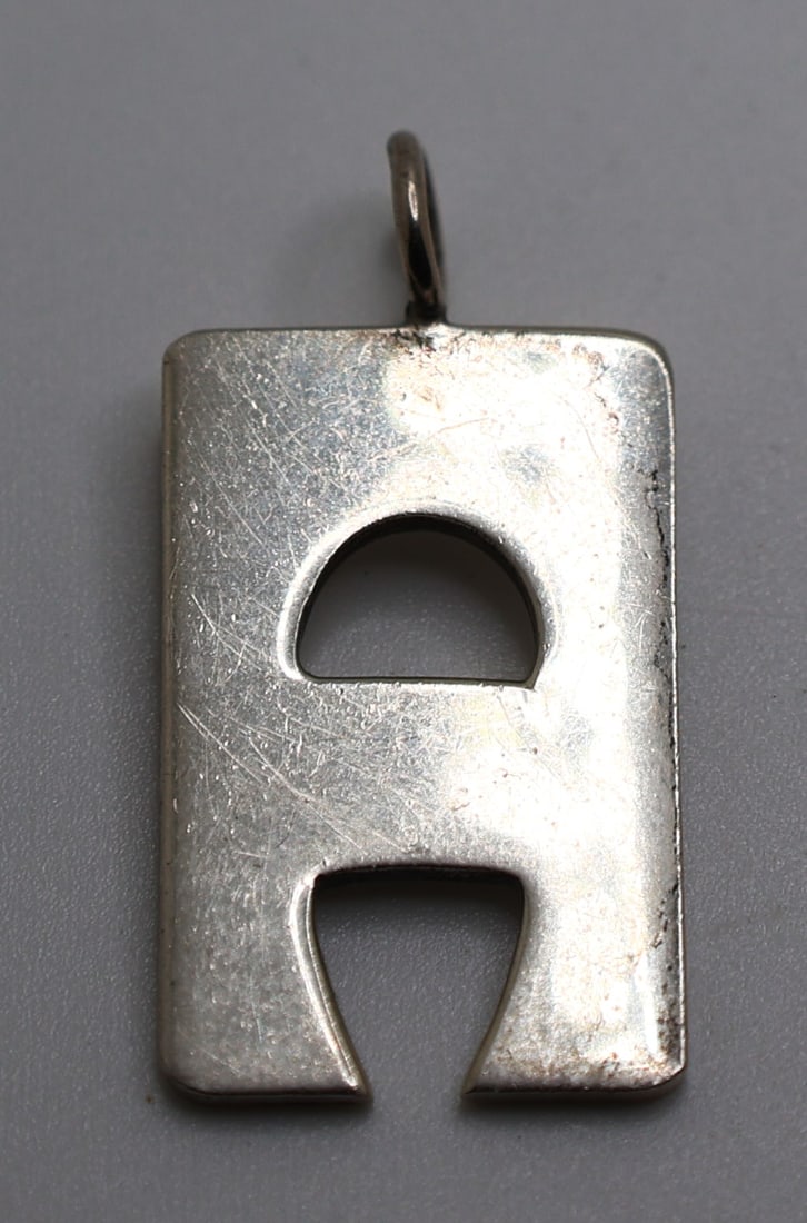 CARTIER "Modernism Cut-Out" Sterling Silver Pendant 1 1/2 in. x 3/4 in.: CARTIER "Modernism Cut-Out" Sterling Silver Pendant 1 1/2 in. x 3/4 in.