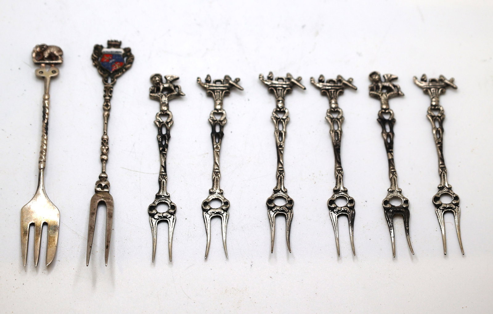 marked 800 Silver 61.5 grams hors d'oeuvres [7] Forks 4.5 in. and [1] Bercht 4 7/8 in. x 3/4 in.: marked 800 Silver 61.5 grams hors d'oeuvres [7] Forks 4.5 in. x 5/8 in. and [1] Bercht 4 7/8 in. x 3/4 in.