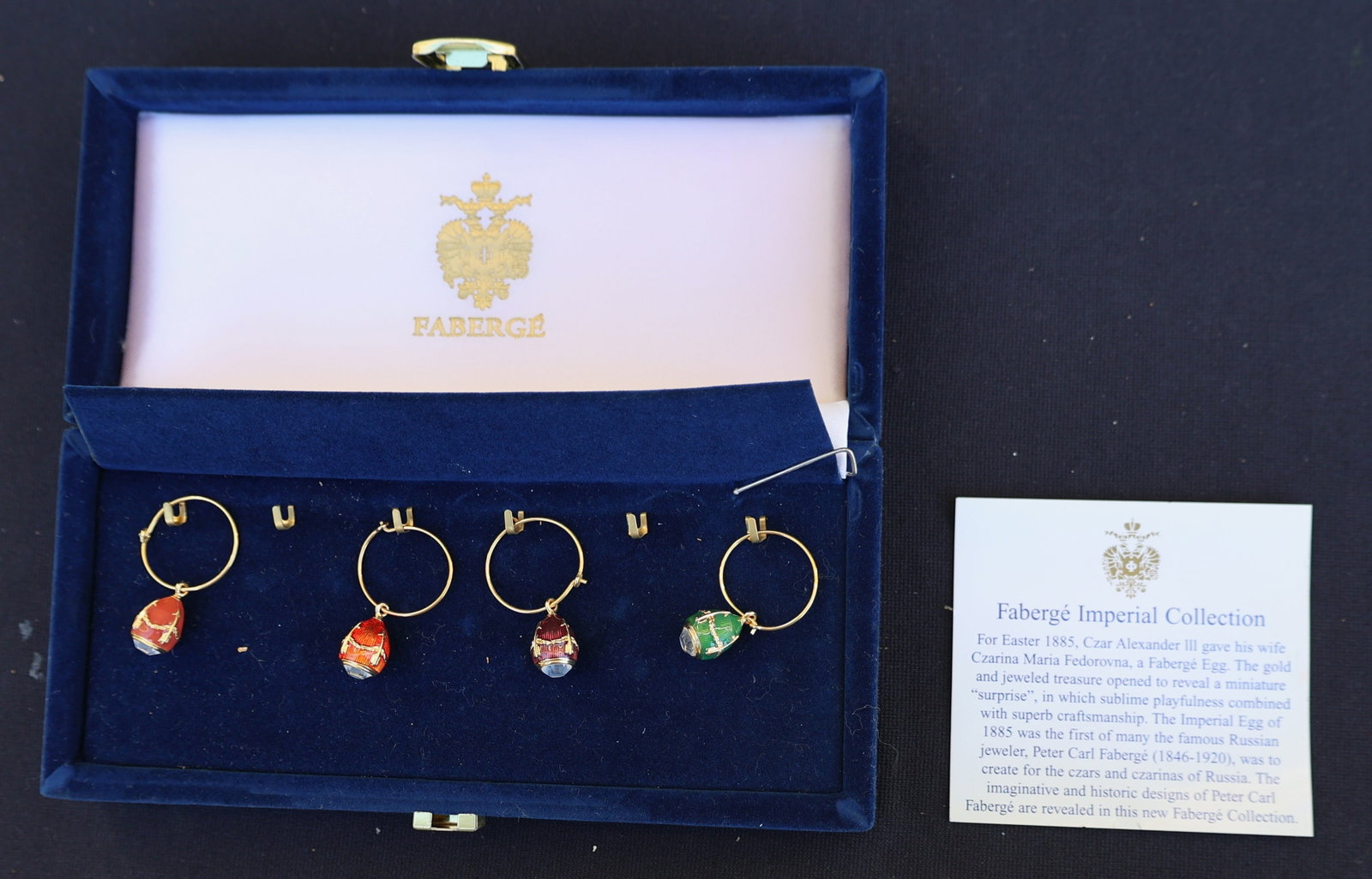 Set of 4 Fabergé Imperial Collection Wine Glass Charms.in Velvet Presentation Box: set 4 of Fabergé Imperial Collection wine glass charms. The charms are designed in the style of the famous Fabergé eggs, featuring enamel on a gold-plated sterling silver base. Each charm has a uniq