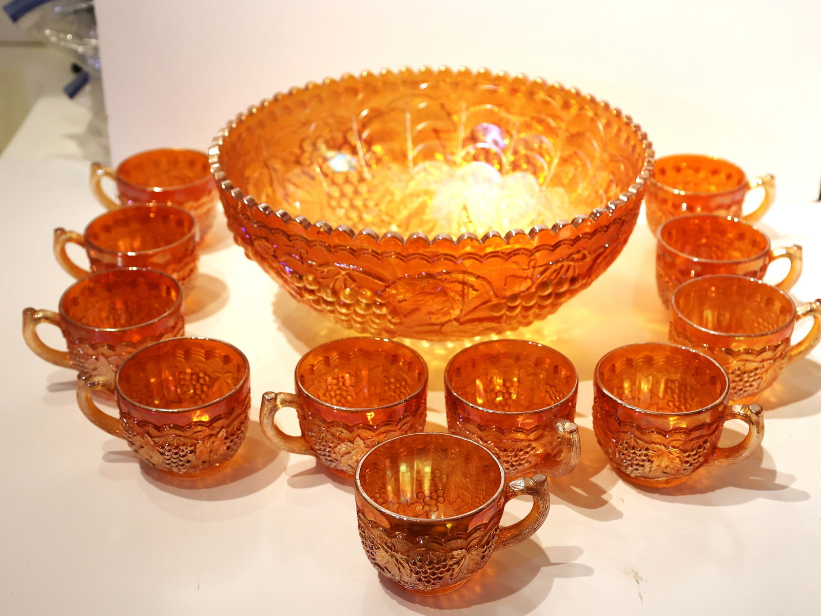 12 pcs. Vintage Marigold Carnival Glass Punch Bowl Set featuring a prominent grape and vine pattern (1 of 7)