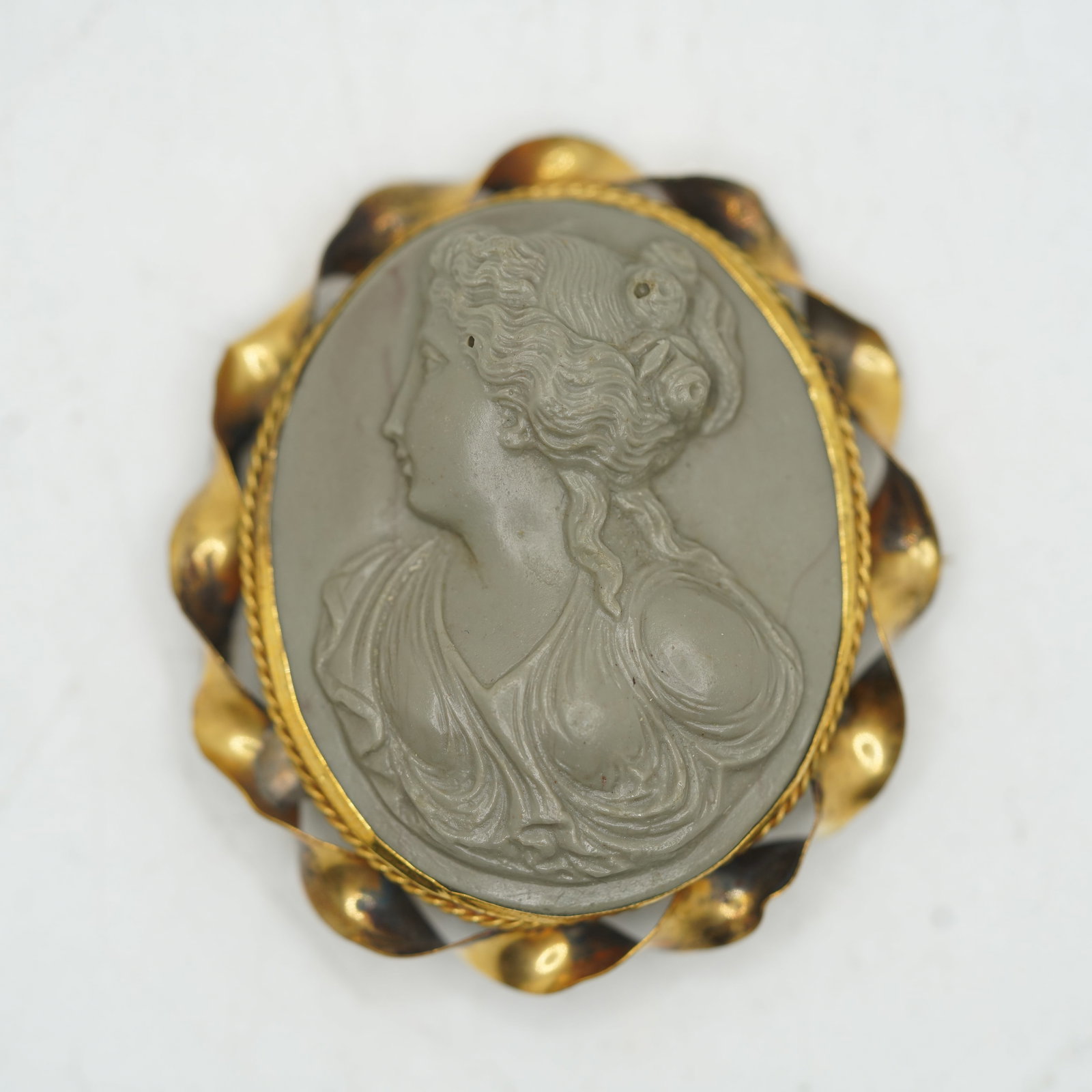 Circa 1860s Grey Gutta Percha Cameo Pin Incased in a Gold Filled Frame 2 in. x 1 3/4 in.: Circa 1860s Grey Gutta Percha Cameo Pin Incased in a Gold Filled Frame 2 in. x 1 3/4 in.