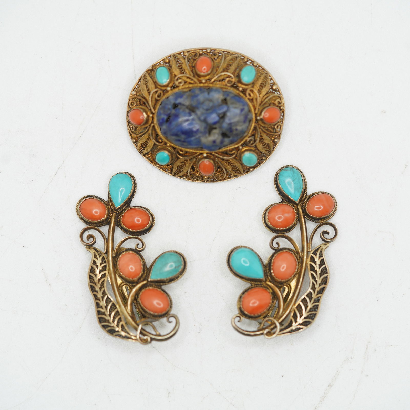 3 Piece .800 Silver Brooch Carved Lapis Center Stone Elaborate Filigree Setting Adorned With: 3 Piece .800 Silver Brooch Carved Lapis Center Stone Elaborate Filigree Setting Adorned WithCoral and Turquoise Stones Pin 1 1/2 in. x 1 1/4 in. ; Marked 58 Silver Clip Earrings Filigree with Coral an