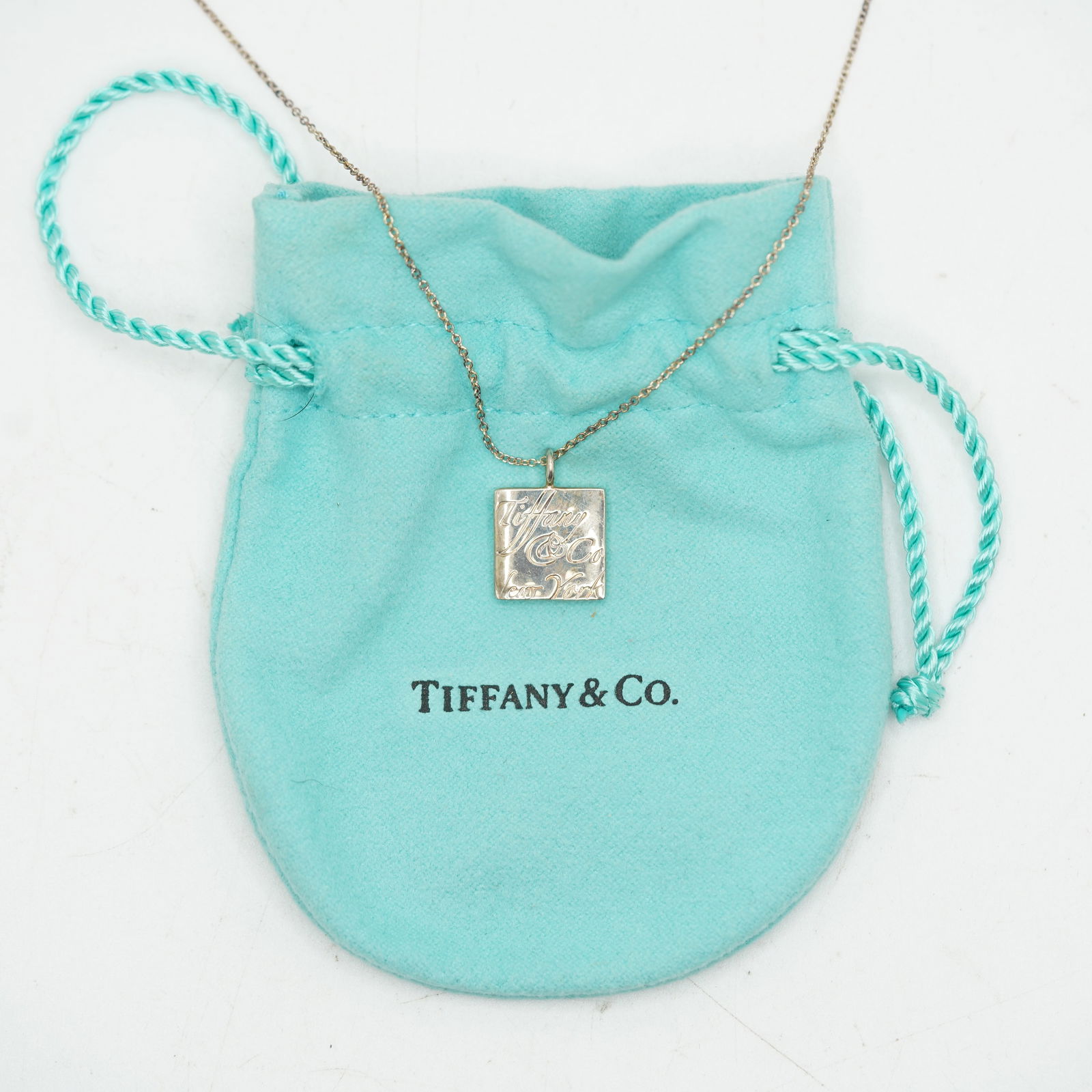 Tiffany & Co .925 Sterling Silver New York Pendant Necklace on Tiffany & Co .925 Chain 16 in.: Tiffany & Co .925 Sterling Silver New York Pendant 1/2 in.x 3/4 in. Necklace on Tiffany & Co .925 Chain 16 in. with Fabric Pouch