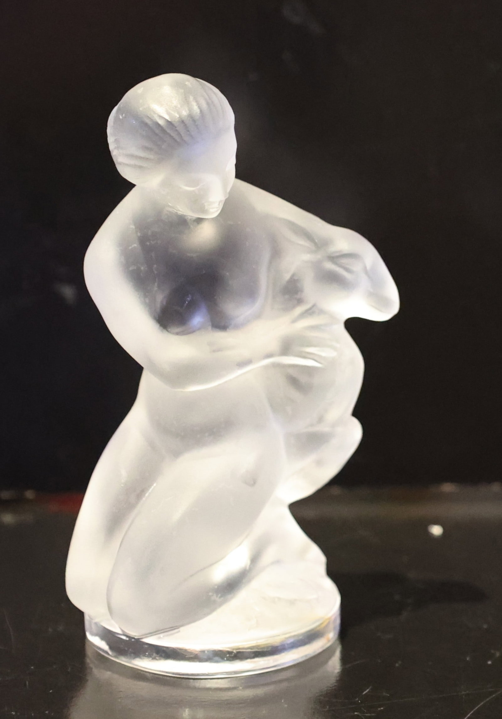 Lalique France Figure Woman With Lamb, "Diana the Huntress" frosted crystal figurine: Size: 4.25 inches height x 2.5 inches wide x 2 inches dia. base; Lalique France Figure Woman With Lamb, "Diana the Huntress" frosted crystal figurine. The piece depicts a nude woman, the Roman goddess