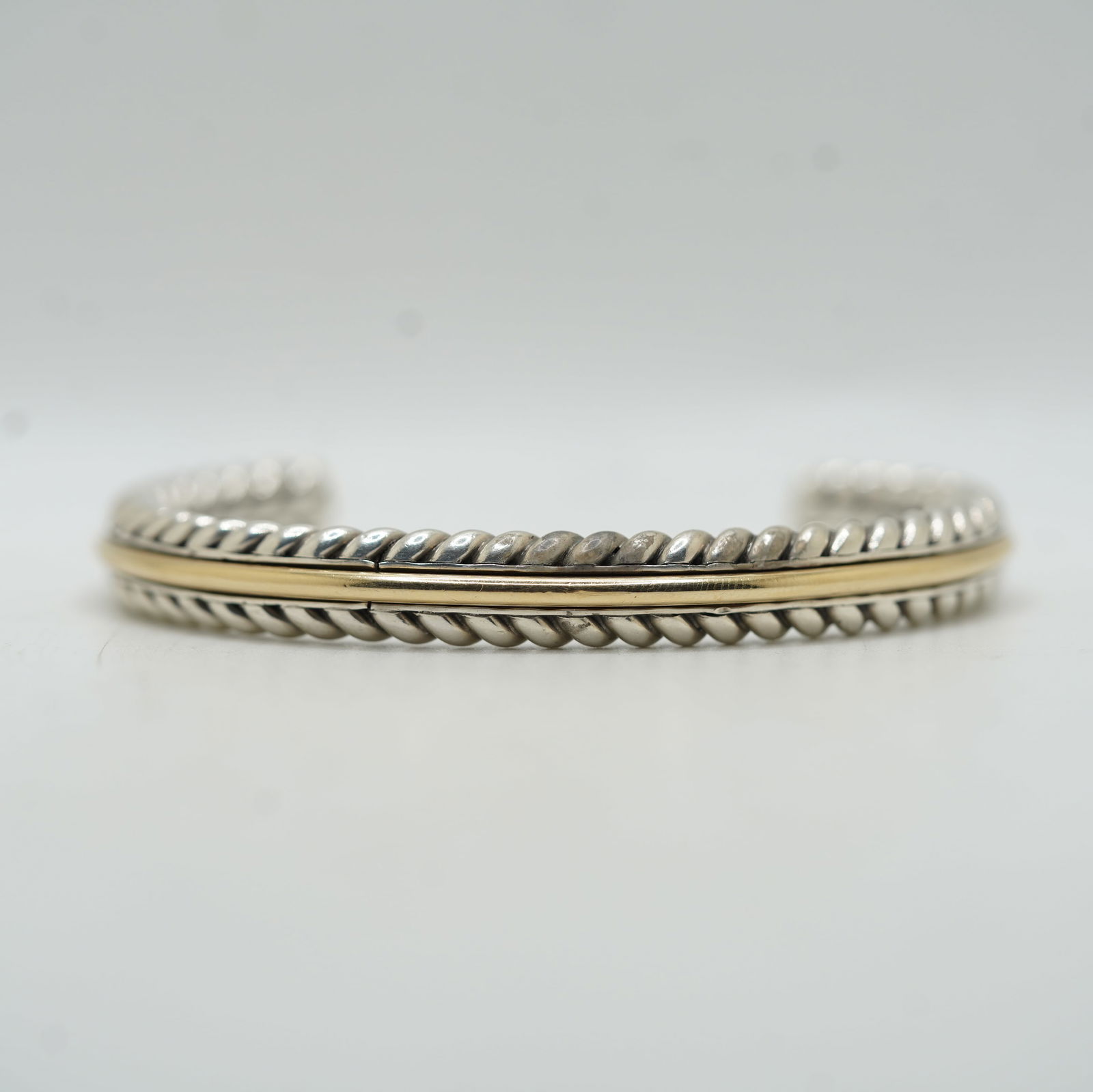 48.48 Grams Total Weight Sterling Silver Rope Twist Cuff Bracelet w/ 12 Grams 14k Gold Band Strip: 48.48 Grams Total Weight Sterling Silver Rope Twist Cuff Bracelet w/ 12 Grams of 14k Gold Band Strip Down The Center of The Bracelet. ; 2 7/8 x 2 1/2 x 3/8