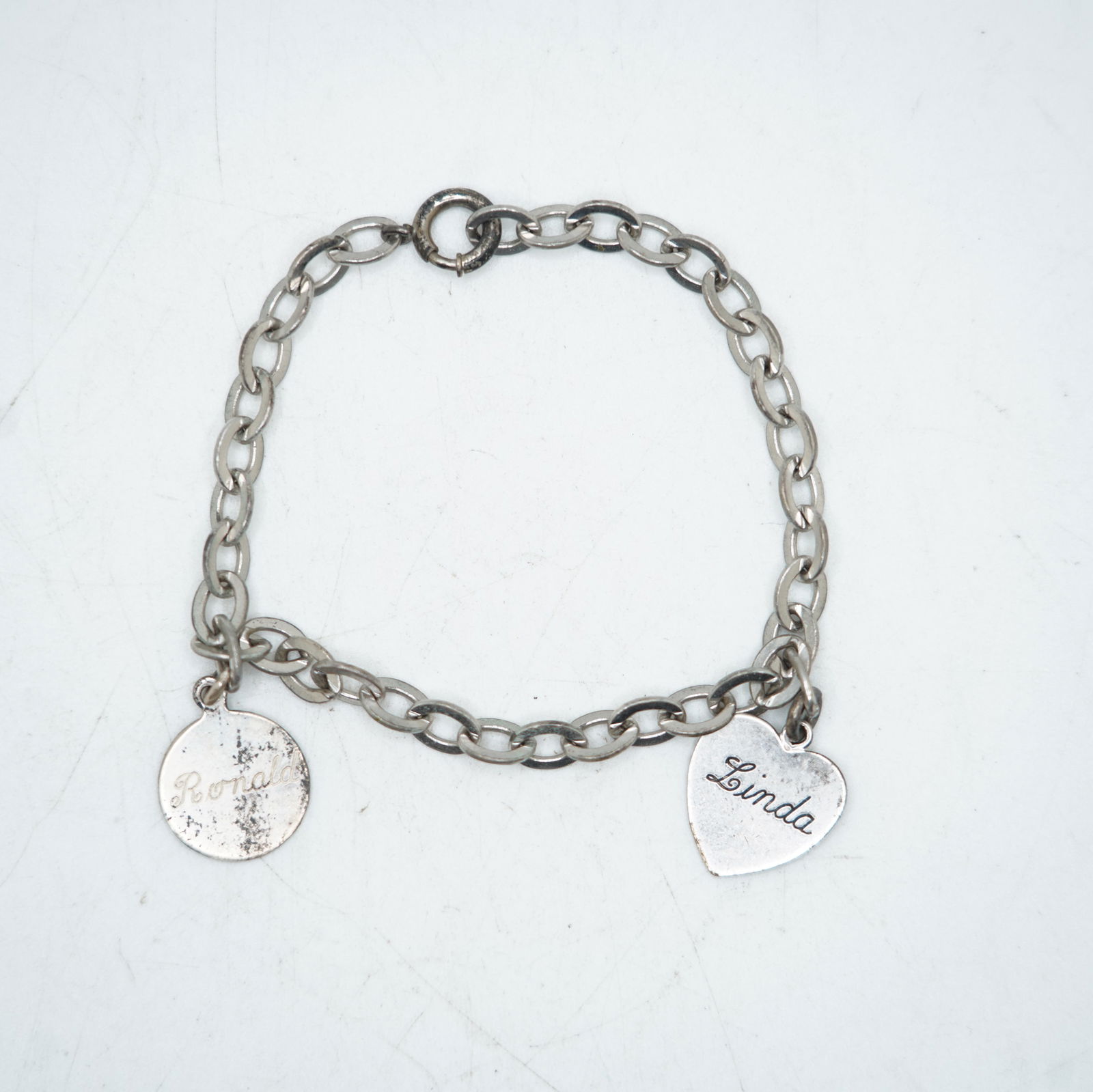 10.15 Grams .925 Sterling Silver Charm Bracelet with 2 Sterling Charms, 8 in. x 1/4 in.; 5/8 in. dia: 10.15 Grams .925 Sterling Silver Charm Bracelet with 2 Sterling Charms, 8 in. x 1/4 in.; 5/8 in. dia