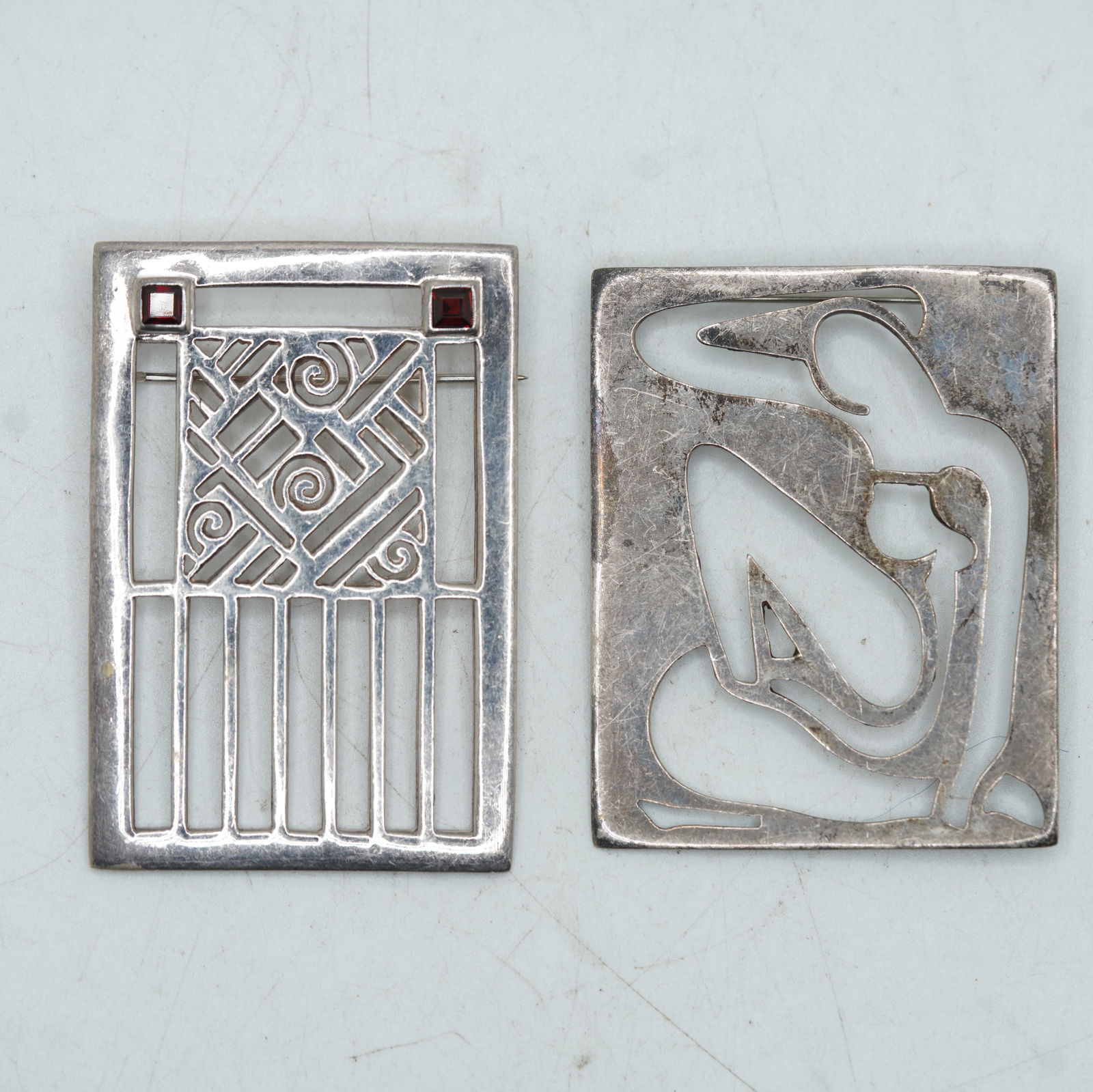 49.45 Grams .925 Sterling Silver [2] Mid-Century Modern Cut-Out Figure Pin & .925 J-J 2 Garnets: 49.45 Grams .925 Sterling Silver [2] Mid-Century Modern Cut-Out Figure Pin 2 1/4 in. x 1 7/8 i. & .925 J-J 2 Garnets Gate Pin 2 1/2 in. x 1 3/4 in.