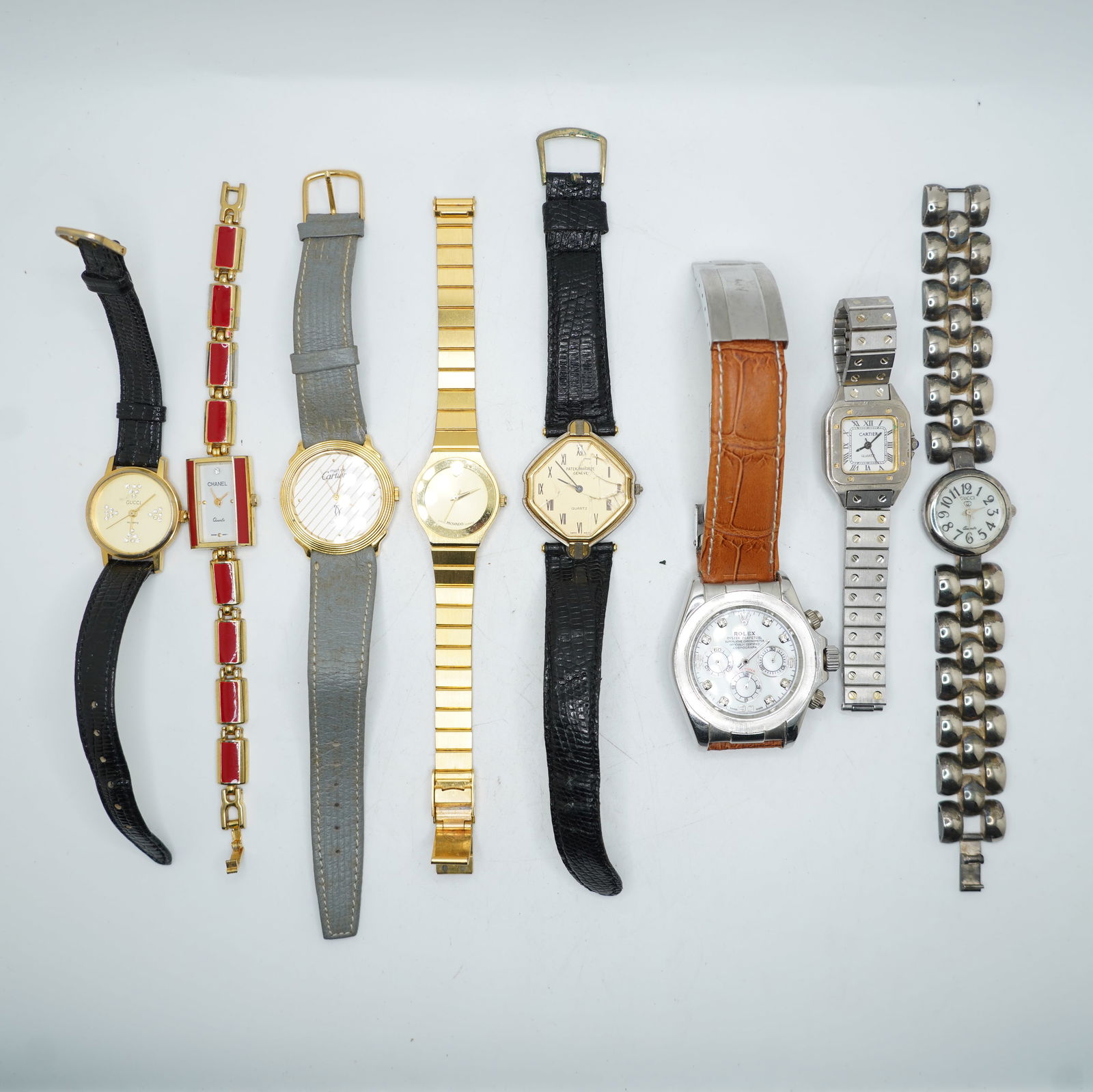 Replica/Novelty Lot of 8 Designer Style Wristwatches: This lot includes eight replica / novelty wristwatches styled after various designer luxury brands. These watches are not authentic and are being sold strictly as novelty pieces.