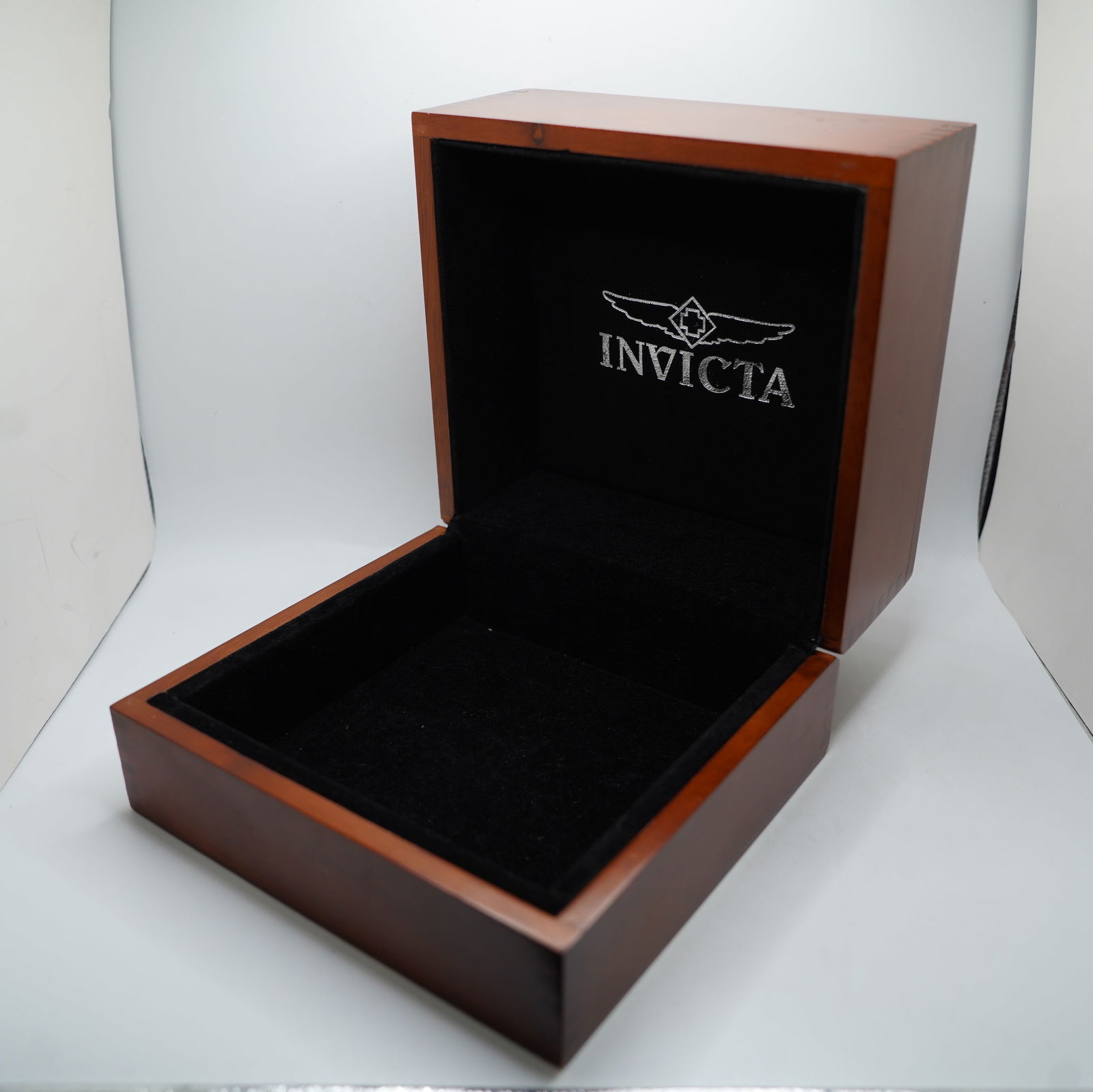 Invicta Wooden Watch Box – Tongue & Groove Construction: Pre-owned Invicta wooden watch presentation box featuring tongue and groove construction. The exterior shows light surface wear consistent with normal use, but overall the box is solid and in good con