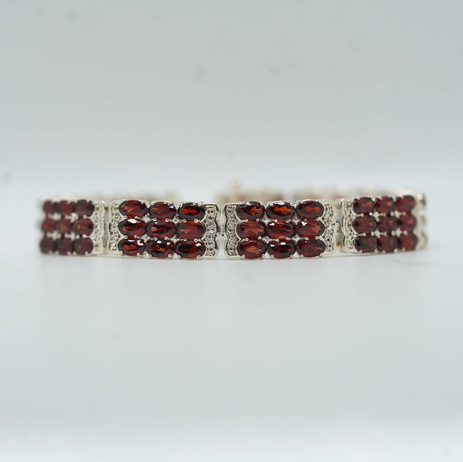 21.74 Grams Total Weight Gorgeous .925 Sterling Silver With Garnets Tennis Bracelet: 21.74 Grams Total Weight Gorgeous .925 Sterling Silver With Garnets Tennis Bracelet. Size: 7 in. x 3/8 in.