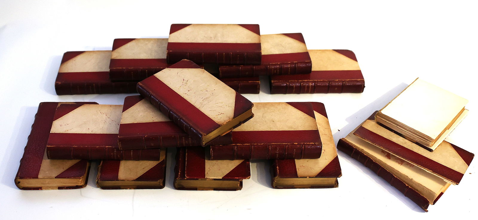 [16] 14 Leather Bound Books Plus 2 As-Is Binders - Half Leather Bindings: antique books with fine leather bindings, often referred to as half-leather bindings due to the material covering the spine and corners. The bindings typically feature red leather spines with decorati