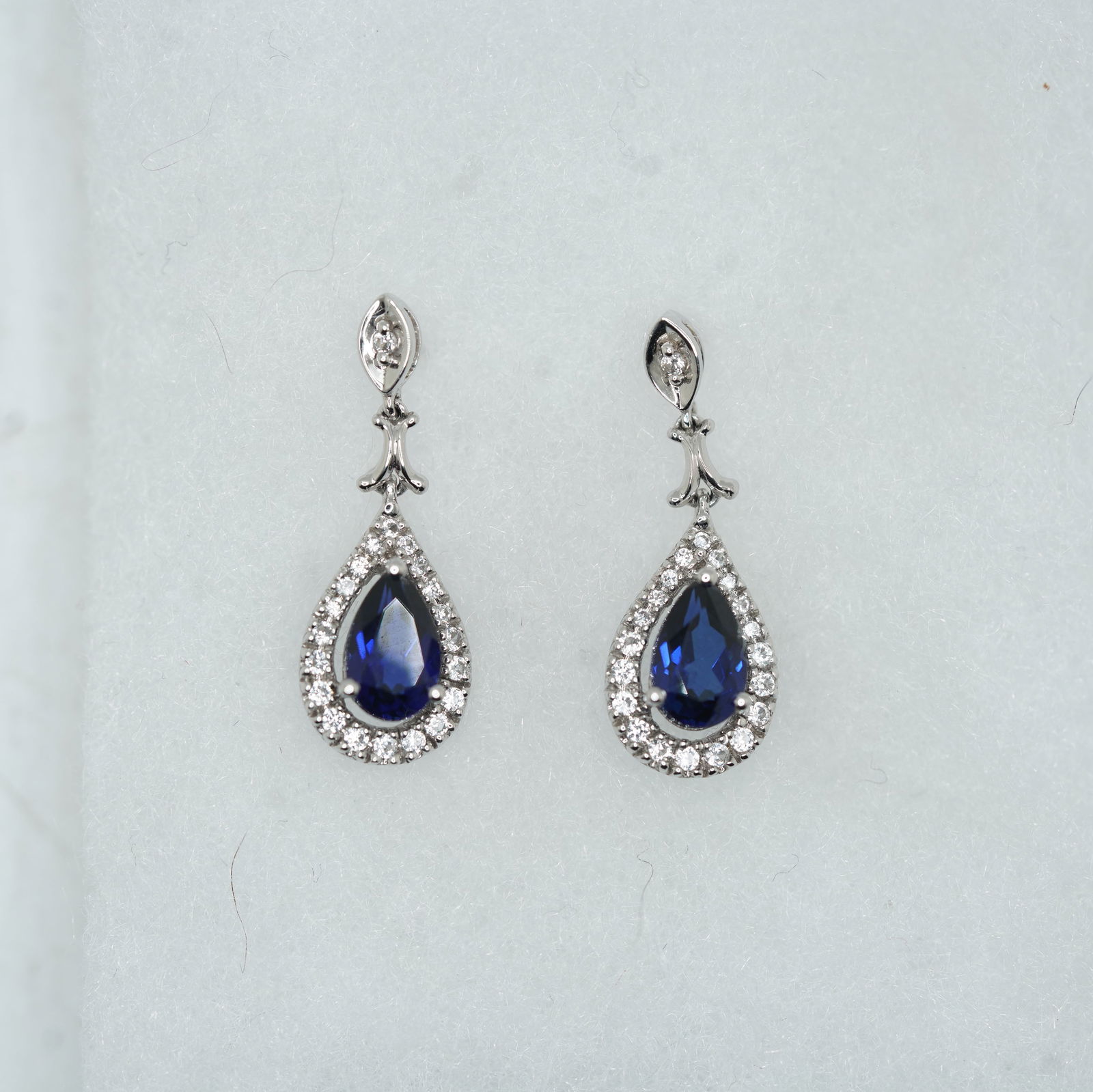 2.11 DWT 10K White Gold Tear Shaped Blue Sapphire Surrounded by White Topaz Drop Earrings (1 of 13)
