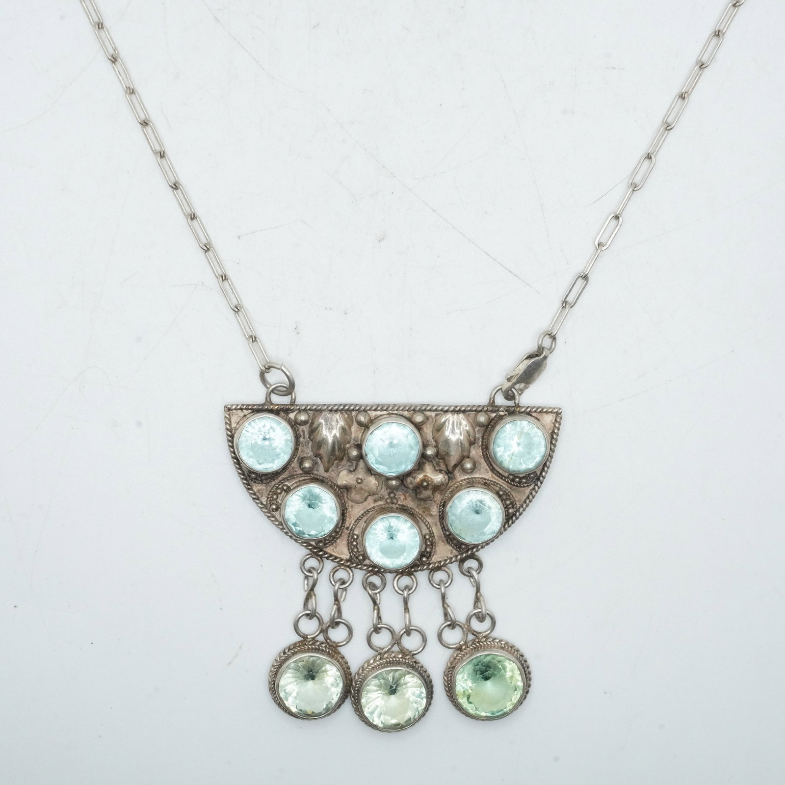 26.64 Grams Sterling Silver Blue Topaz Stones with 6 Set in Drop Fringe Pendant: 26.64 Grams Sterling Silver Blue Topaz Stones with 6 Set in Drop Fringe Pendant. Size: pendant 2 1/8 in. x 2 1/8 in. ; 24 in. length chain