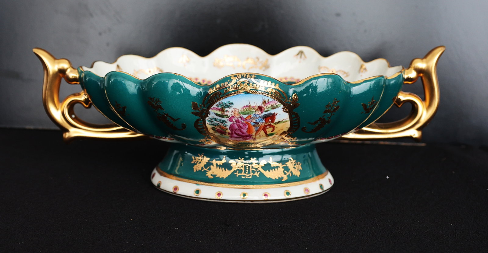 1940s Serves Green Porcelain Centerpiece Compote with Gold Gilt Handles, Courting Scene: 1940s Serves Green Porcelain Centerpiece Compote with Gold Gilt Handles, Courting Scene . Size: 5 1/4 in. height, 14 3/4 in. length handle to handle, 11 1/2 in. x 8 in. bowl