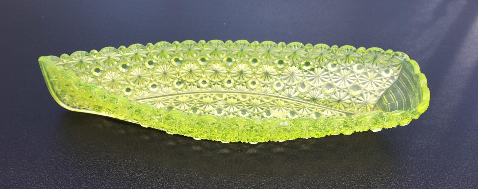 Vaseline, Uranium Glass Hobbs, Brockunier & Co. Daisy and Button Relish Dish, Shaped like a Canoe: Size: 2 in. height, 14 inches length, 4 3/4 in. wide; Hobbs, Brockunier & Co. Daisy and Button pattern relish dish, shaped like a canoe and made of uranium glass (also known as Vaseline glass).