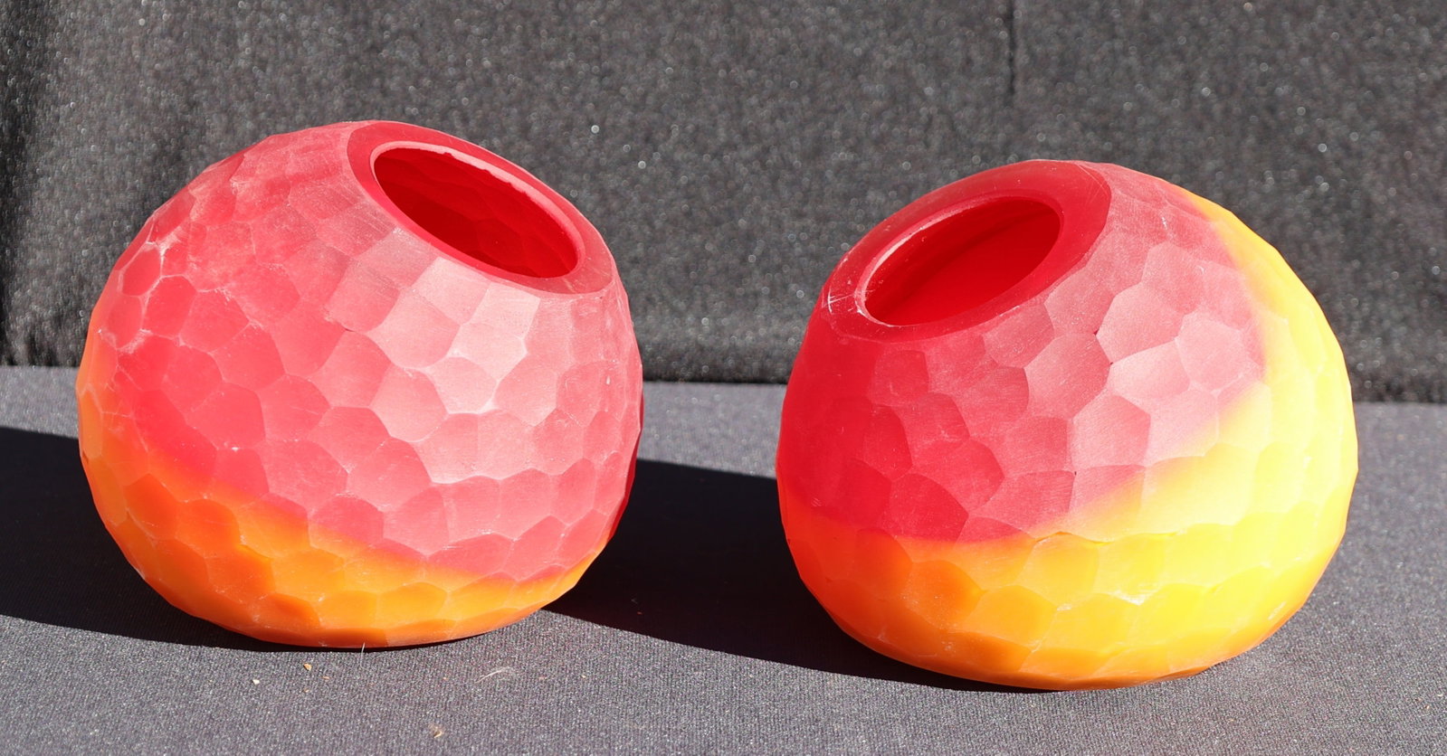 [2] Micheluzzi Murano glass "Riccio" or "Battuto" style faceted ball vases featuring a vibrant red-t: Size: 6 in. diameter; 2 Micheluzzi Murano glass "Riccio" or "Battuto" style faceted ball vases featuring a vibrant red-to-amber ombre