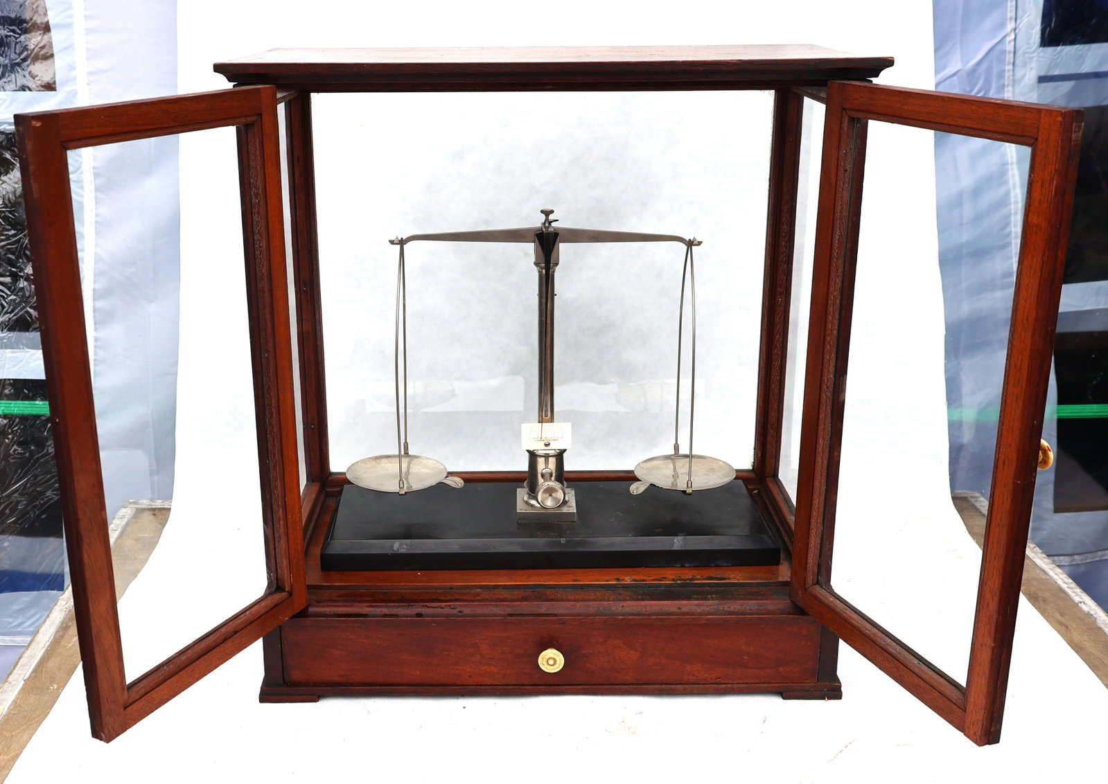 antique mahogany-cased balance scale features a vertical sliding glass door and a lower storage draw - 3